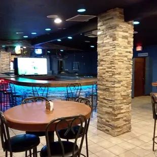 a view of a restaurant with tables and chairs