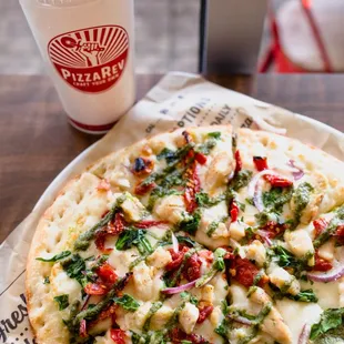 a pizza and a drink on a table