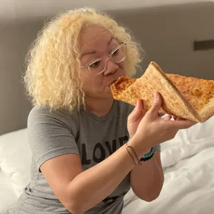 a woman eating a slice of pizza