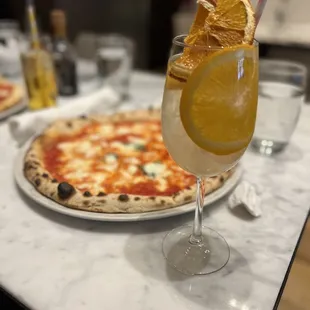 a glass of lemonade and a pizza