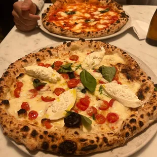 two pizzas on a table