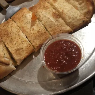 a slice of bread with tomato sauce