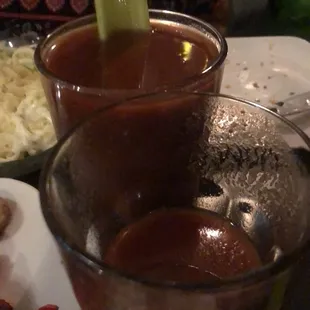a glass of hot sauce with a celery garnish