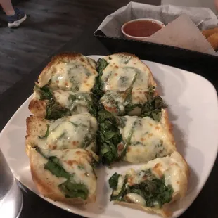 a white plate with four pieces of pizza on it