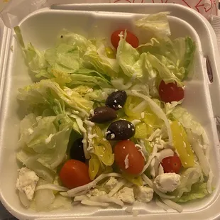 a salad in a styrofoam container