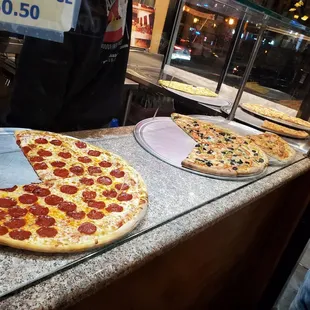 two pizzas on a counter