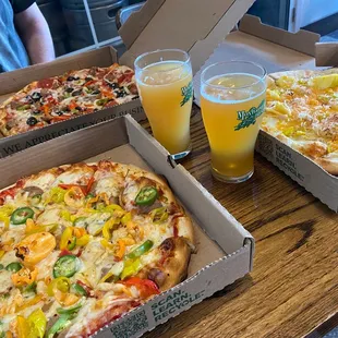 pizzas and drinks on a table