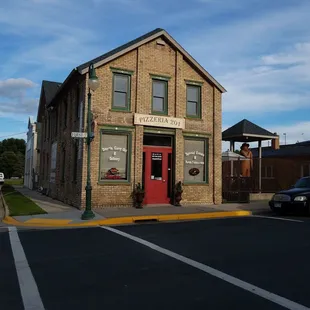 a brick building with a red door