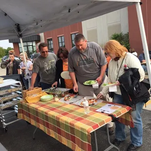 a group of people standing around a table