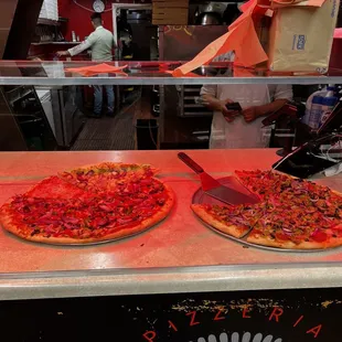 two pizzas on display