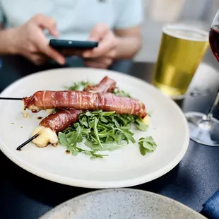 Spiedini (Fontina cheese wrapped in prosciutto). Side of arugula works perfectly with rich and salty.