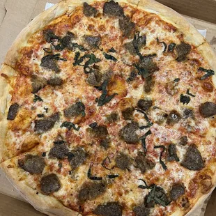 Large pizza with meatballs and basil