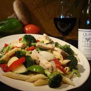 a plate of pasta with chicken and vegetables