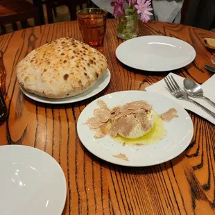 three plates of food on a wooden table