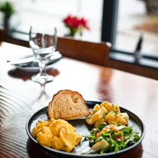 Scrambled eggs with potatoes, home-made bread and salad.