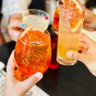 a group of people toasting with drinks