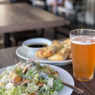 a plate of salad and a glass of beer