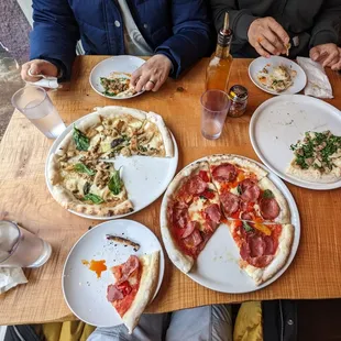 people eating pizza at a restaurant