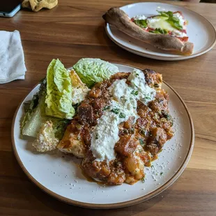 Caponata pizza with a side Caesar salad