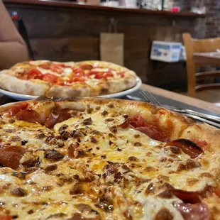 two pizzas on a table