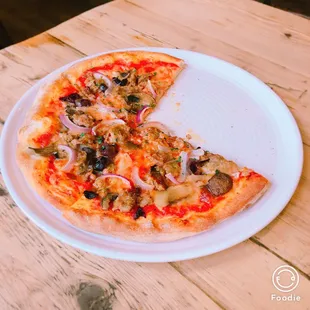 a half eaten pizza on a plate