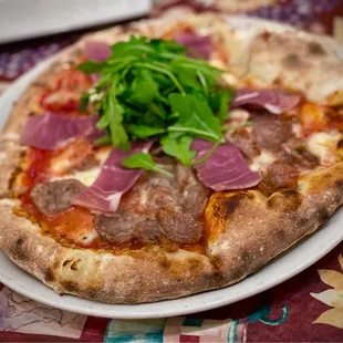 Rustica pizza with sausage on 1/2.