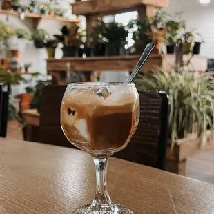 a glass of coffee on a table