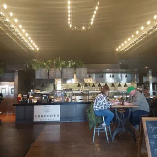 people sitting at tables in a restaurant