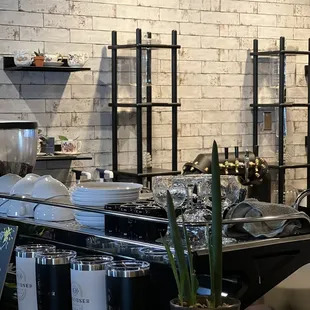 a restaurant counter with plates and cups on it