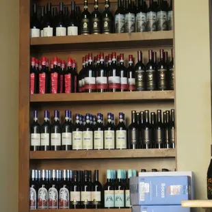 a shelf of wine bottles