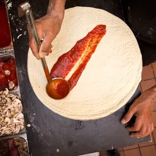 a person making a pizza