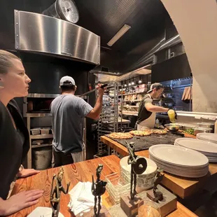 Open kitchen and assembly line of great pizza creations!