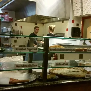 The kitchen area and pizza case