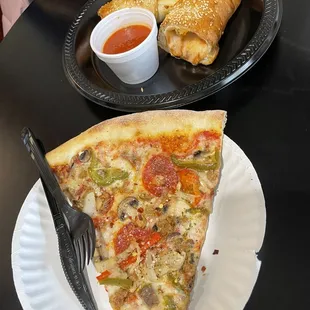 a slice of pizza on a paper plate