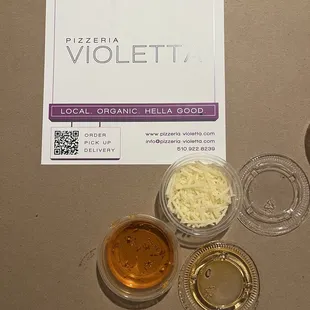 The pepper oil and shredded parmigiana for the pizza