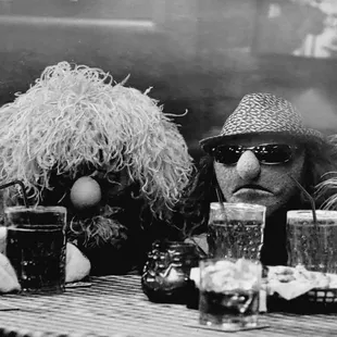 three puppets sitting at a table