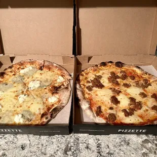 Quattro Formaggi pizza on the left, Bolognese pizza on the right.