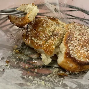 Garlic knots! Look at that &quot;flavor&quot; coating the paper. I can&apos;t eat them fast enough.