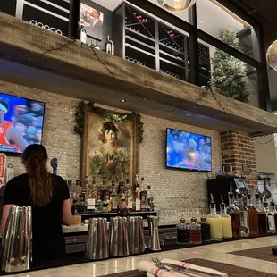 a bar with two televisions