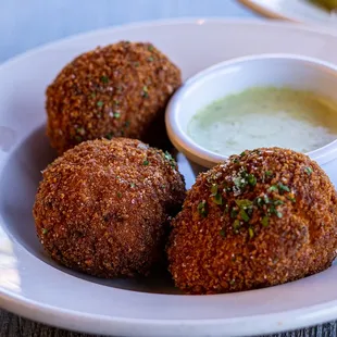 a plate of food with dipping sauce
