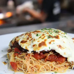 a plate of spaghetti with meat and cheese