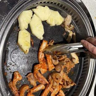Cooking our pineapple, calamari and spicy octopus