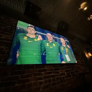 a group of soccer players on a tv screen