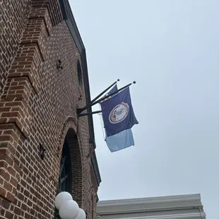 a blue and white flag on a pole