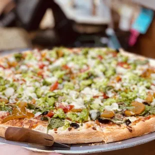 a hand holding a pizza