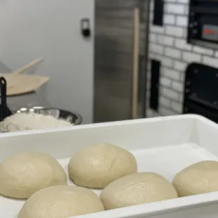 six uncooked doughs in a pan