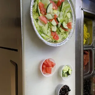 a bowl of salad and bowls of olives