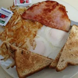 A two egg combo ham overeasy eggs, hash browns,and wheat toast