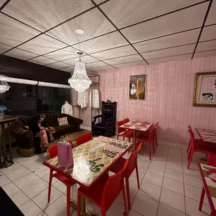 a dining room with pink walls
