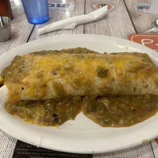 Bacon breakfast burrito smothered in green chili